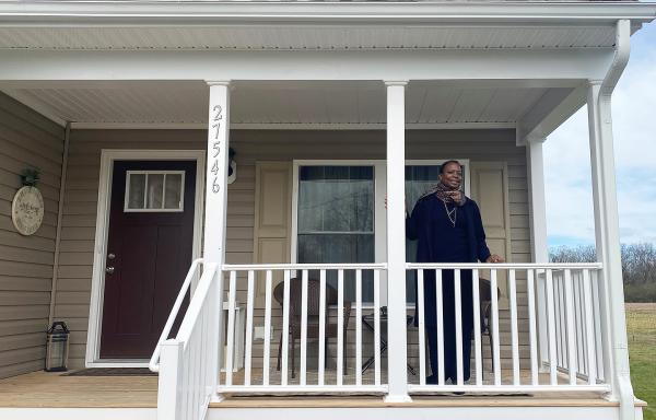 Cora Suzette Lee on the front porch of her new home.