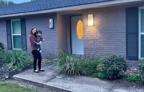 New homeowner Kaitlyn and son with new home funded by Rural Development Single Family Housing loan. 