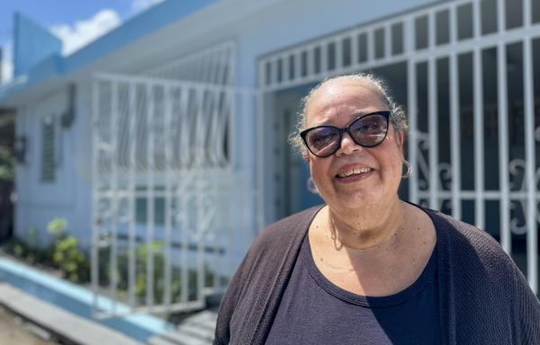 Iris standing in front of her house in Loiza, Puerto Rico